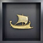 Τριήρης, Κόρινθος, Χάλκινη επίχρυση 24Κ ανάγλυφη παράσταση του αρχαίου πολεμικού πλοίου, τοποθετημένο σε μαύρη ξύλινη κορνίζα στο museummasters.gr.